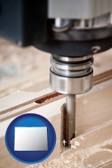 colorado map icon and a CNC milling machine cutting wood