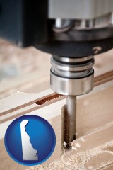 delaware map icon and a CNC milling machine cutting wood