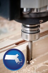 massachusetts map icon and a CNC milling machine cutting wood