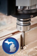 michigan map icon and a CNC milling machine cutting wood