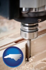 north-carolina map icon and a CNC milling machine cutting wood