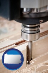 pennsylvania map icon and a CNC milling machine cutting wood