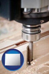 wyoming map icon and a CNC milling machine cutting wood