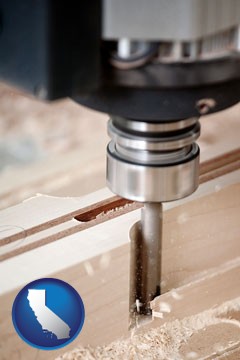 a CNC milling machine cutting wood - with California icon