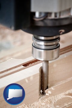 a CNC milling machine cutting wood - with Connecticut icon