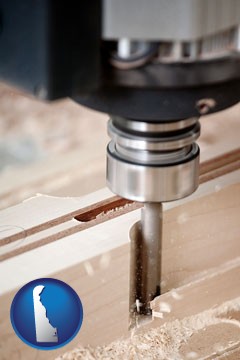 a CNC milling machine cutting wood - with Delaware icon