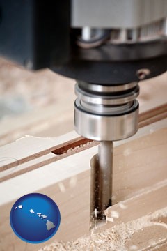 a CNC milling machine cutting wood - with Hawaii icon