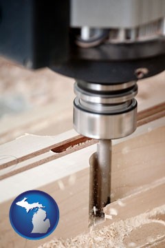 a CNC milling machine cutting wood - with Michigan icon