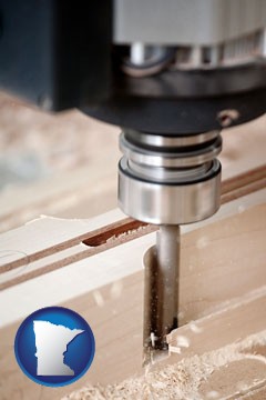 a CNC milling machine cutting wood - with Minnesota icon