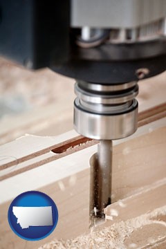 a CNC milling machine cutting wood - with Montana icon