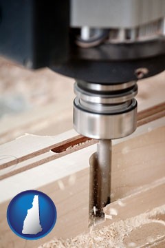 a CNC milling machine cutting wood - with New Hampshire icon