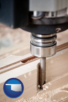 a CNC milling machine cutting wood - with Oklahoma icon