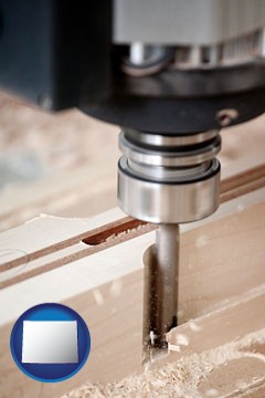 a CNC milling machine cutting wood - with Wyoming icon
